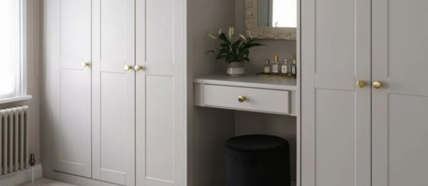 Add a touch of elegance to your space with this minimalistic wardrobe featuring brass accents.